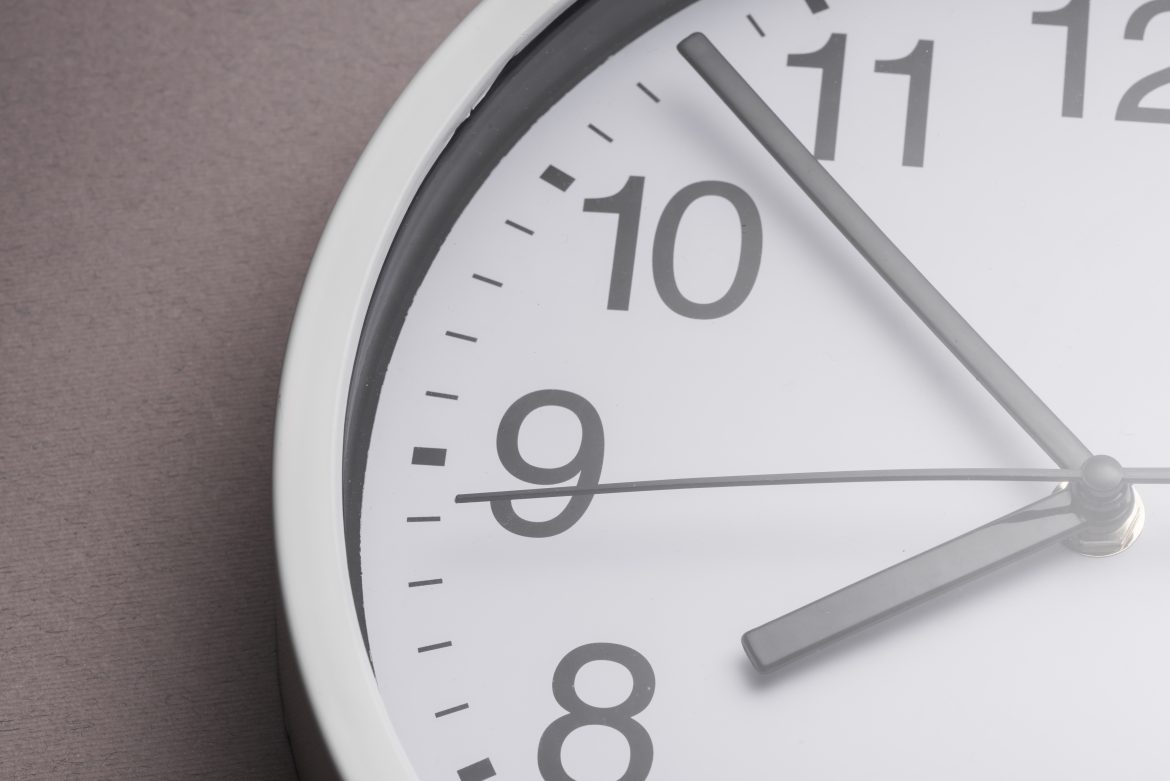 close up white clock ticking showing 8 oclock