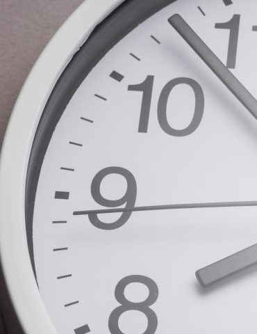 close up white clock ticking showing 8 oclock
